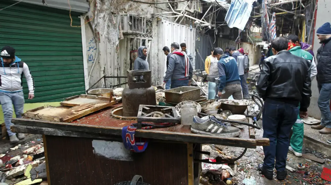 The aftermath of a double bomb attack in a busy market area in Baghdad's central al-Sinaq neighbourhood on December 31, 2016.