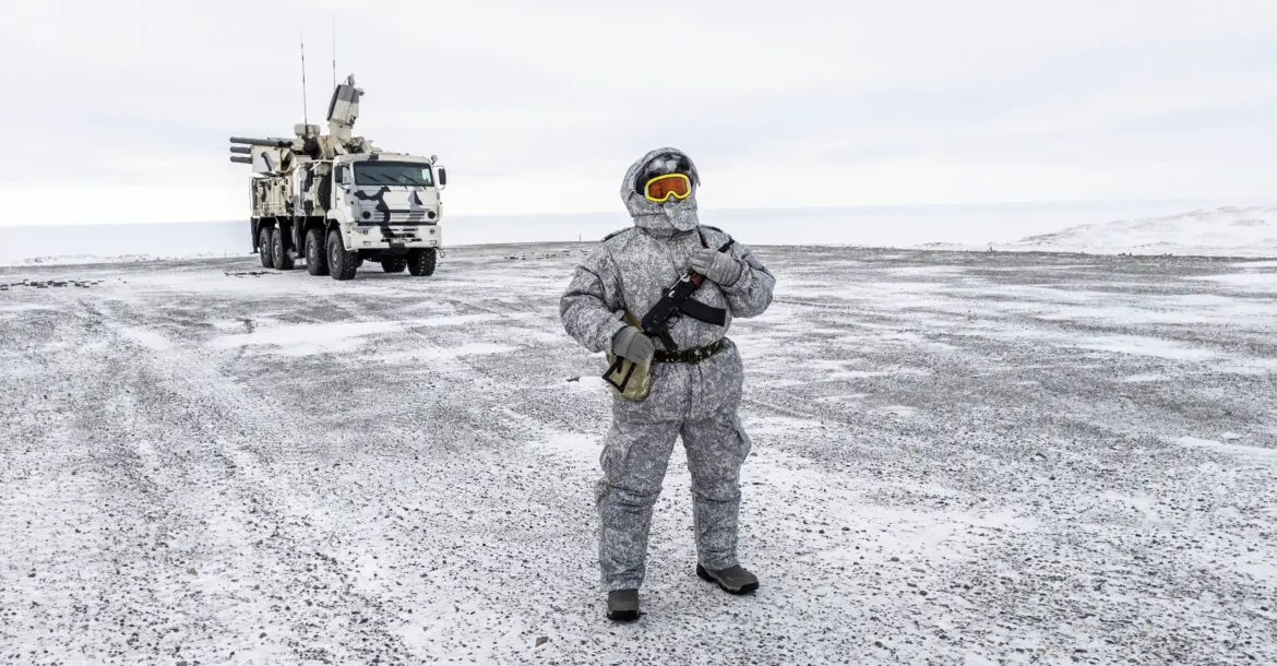 A soldier holds a machine gun as he patrols the Russian northern military base on Kotelny island, beyond the Artic circle on April 3, 2019.