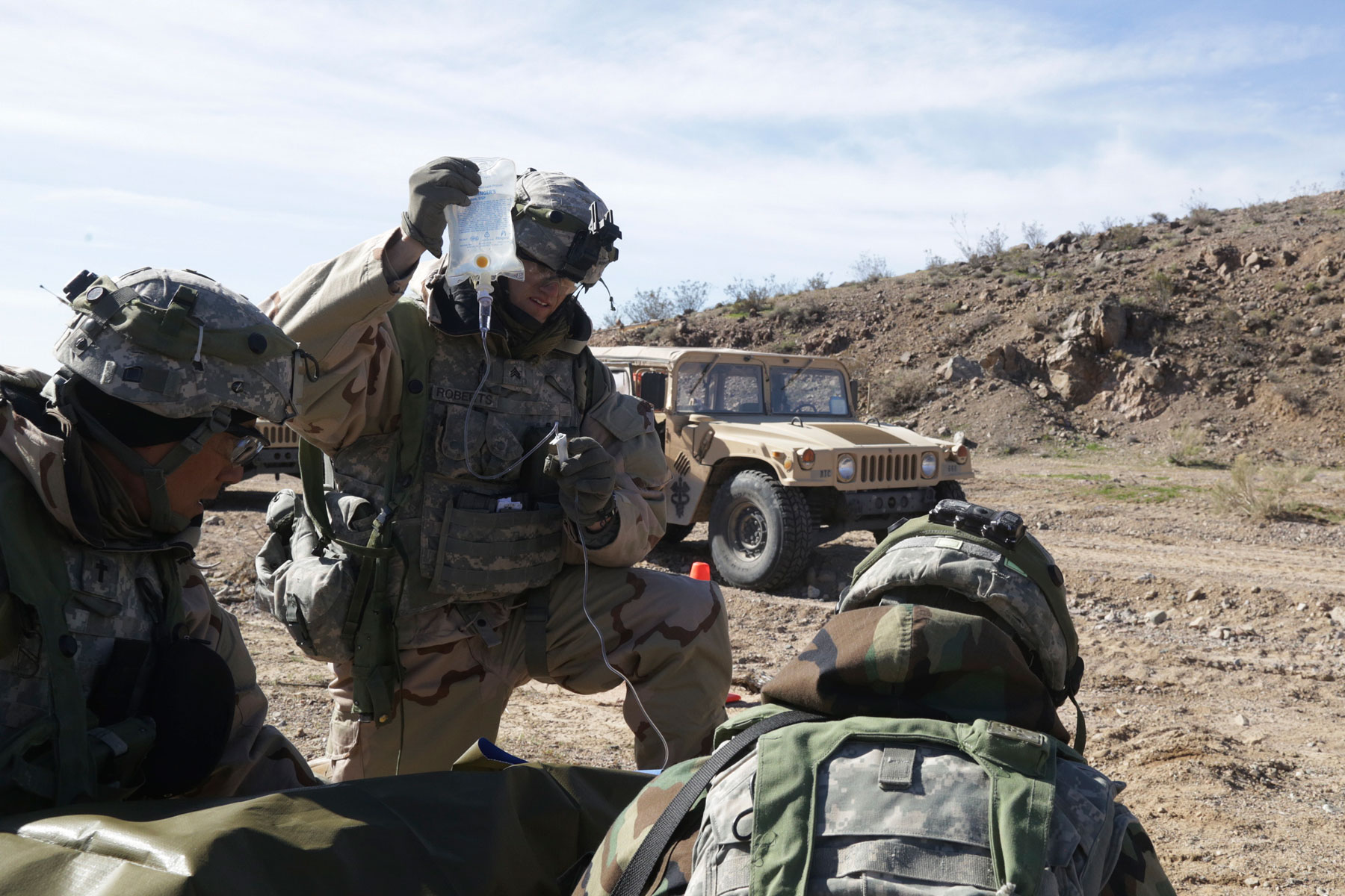 US soldiers assigned to 1st Squadron, 8th Cavalry Regiment, 2nd Brigade Combat Team, 1st Cavalry Division, care for simulated casualties during Decisive Action Rotation 17-04 at the National Training Center in Fort Irwin, California, 2017