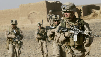 US Marine Sgt. Bryan Early, a squad leader with 1st Battalion, 9th Marine Regiment, leads his squad of Marines to the next compound while patrolling in Helmand province, Afghanistan
