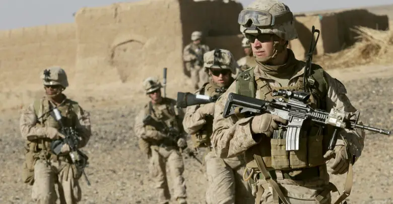 US Marine Sgt. Bryan Early, a squad leader with 1st Battalion, 9th Marine Regiment, leads his squad of Marines to the next compound while patrolling in Helmand province, Afghanistan