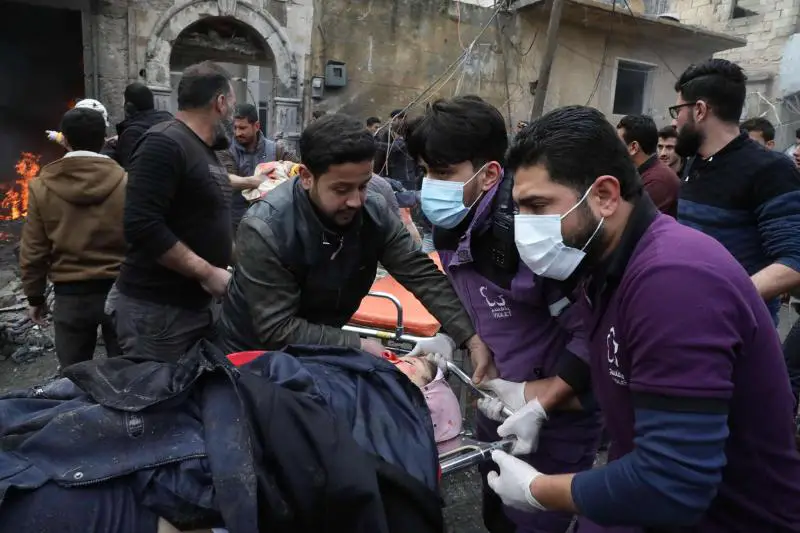 Rescue workers carry away a victim at the scene of an explosion in the town of Azaz in the rebel-controlled northern countryside of Syria’s Aleppo province, January 31, 2021.
