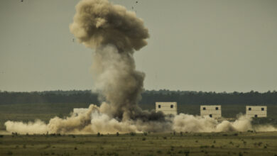 A cloud of heat and smoke erupts from the wreckage after a 1,500 pound explosive detonated in a controlled explosion on the Eglin Air Force Base range