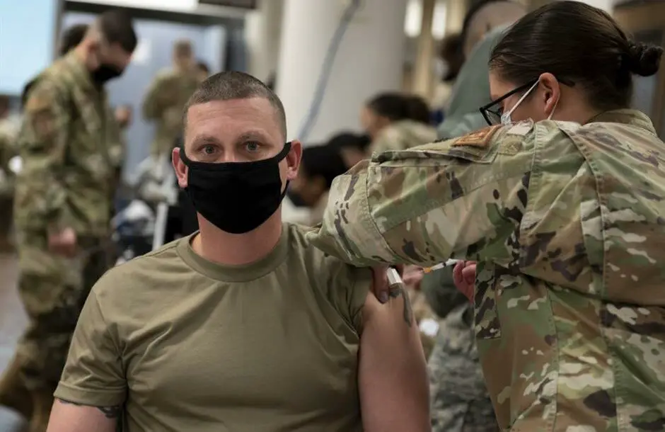In a handout photo taken on December 29, 2020 by US Forces Korea, a service member of the United States Forces Korea receives the first round of the Moderna vaccine at Osan Air Base, south of Seoul