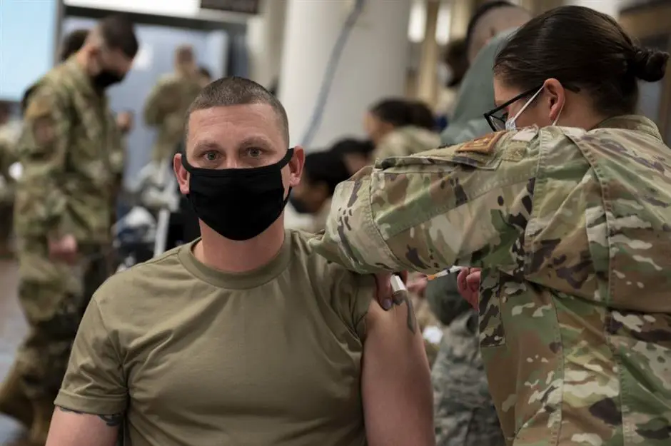 In a handout photo taken on December 29, 2020 by US Forces Korea, a service member of the United States Forces Korea receives the first round of the Moderna vaccine at Osan Air Base, south of Seoul