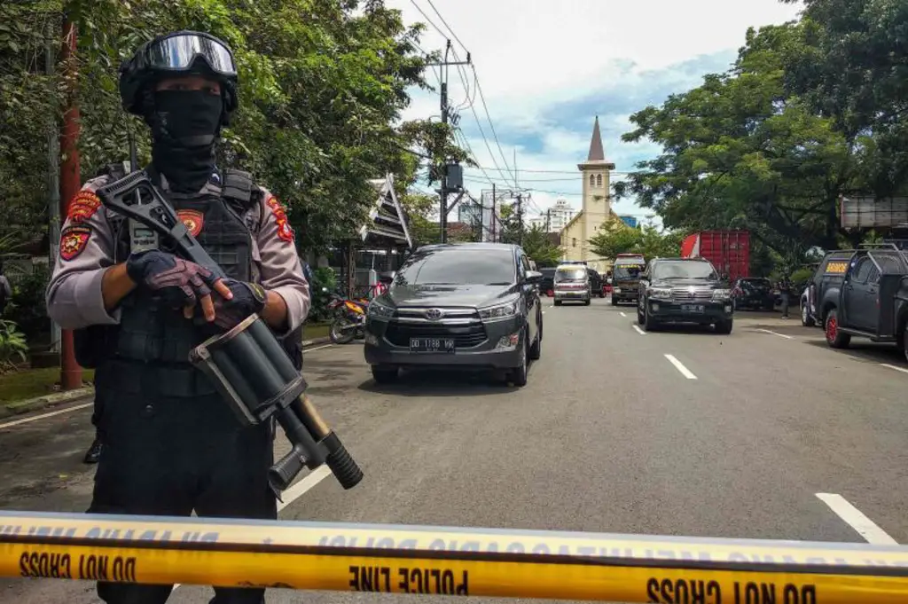 An Indonesian anti-terror policeman stands guard following an explosion outside a church in Makassar, March 28, 2021