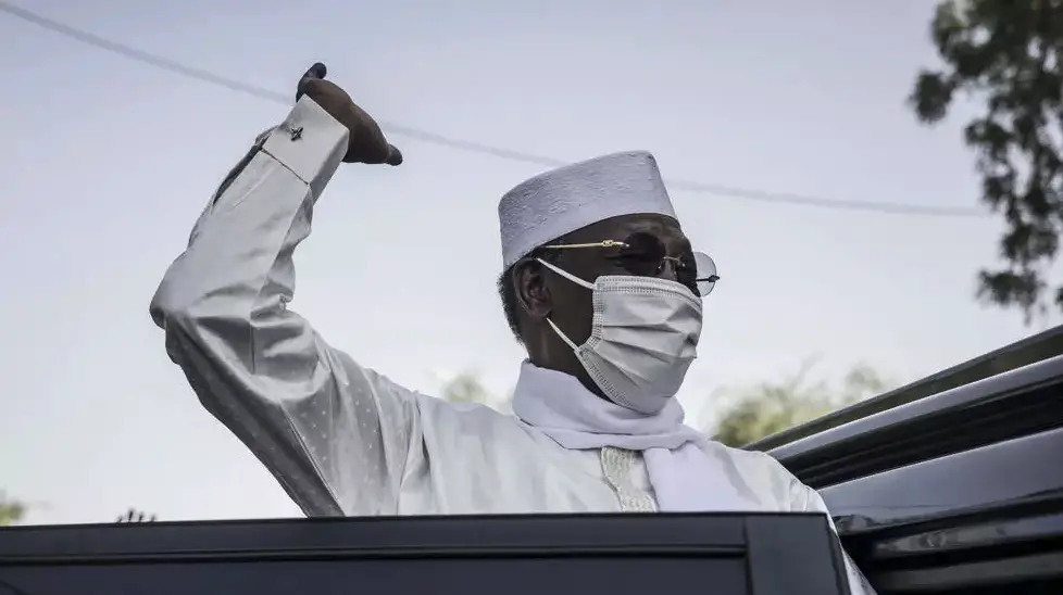 Chadian President Idriss Deby Itno greets supporters as he leaves after casting his ballot at a polling station in N'djamena on April 11, 2021.