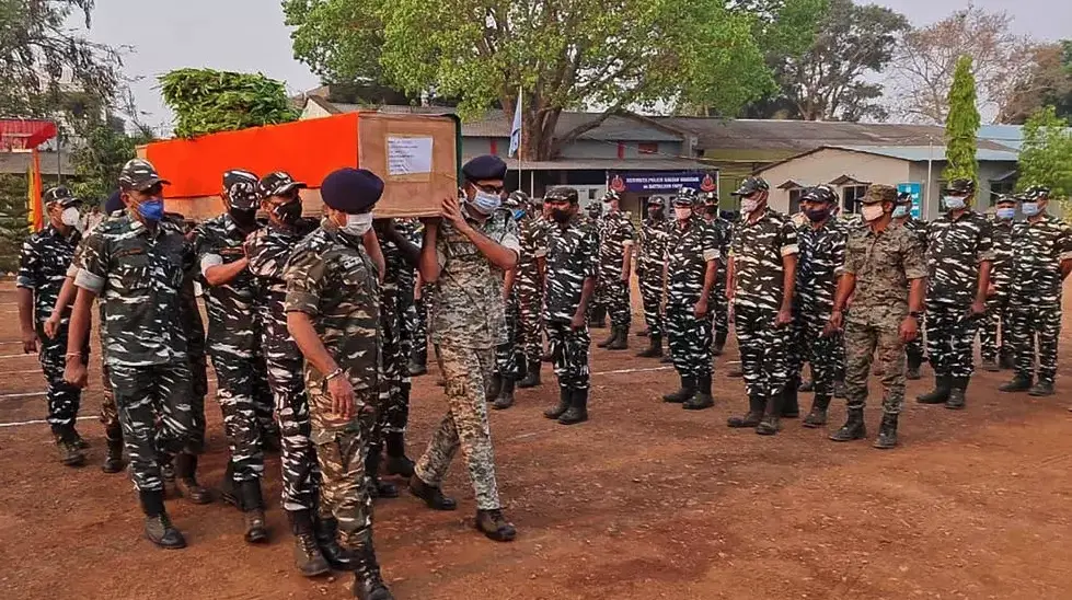 Members of Indian security forces carry the coffin of one of their colleagues, who died following a battle with Maoist rebels in India's Chhattisgarh state, on April 4