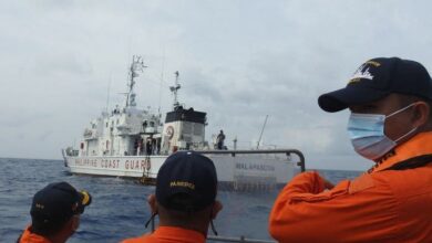 In this undated handout photo received from the Philippine Coast Guard in April, coast guard personnel conduct maritime exercises near Thitu island in the disputed South China Sea