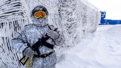 A soldier holds a machine gun as he patrols the Russian northern military base on Kotelny island, beyond the Artic Circle, on April 3, 2019.