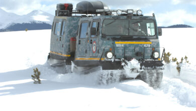 An M973A1 Small Unit Support Vehicle (SUSV) clad in emergency lights and digital camouflage, claws its way through the snow at Taylor Park Reservoir near Gunnison, Colo., March 15, 2010