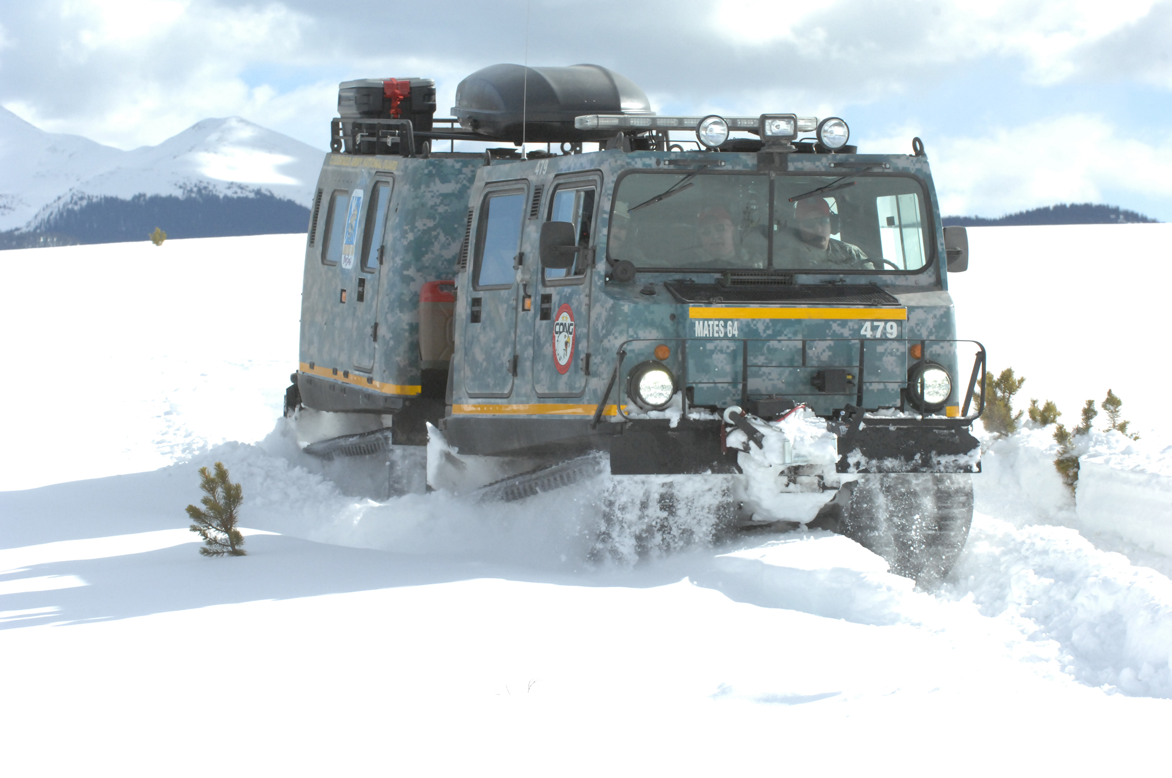 An M973A1 Small Unit Support Vehicle (SUSV) clad in emergency lights and digital camouflage, claws its way through the snow at Taylor Park Reservoir near Gunnison, Colo., March 15, 2010