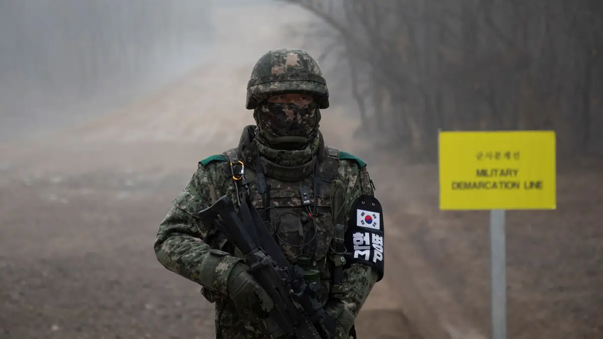 A South Korean soldier stands before the military demarcation line separating North and South Korea