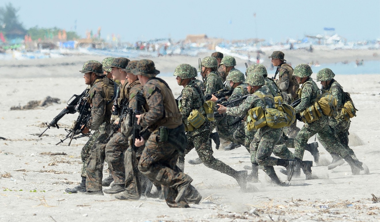 The Philippine and US Marines taking positions during a beach assault exercise facing the South China Sea in San Antonio, Zambales province on May 9, 2014