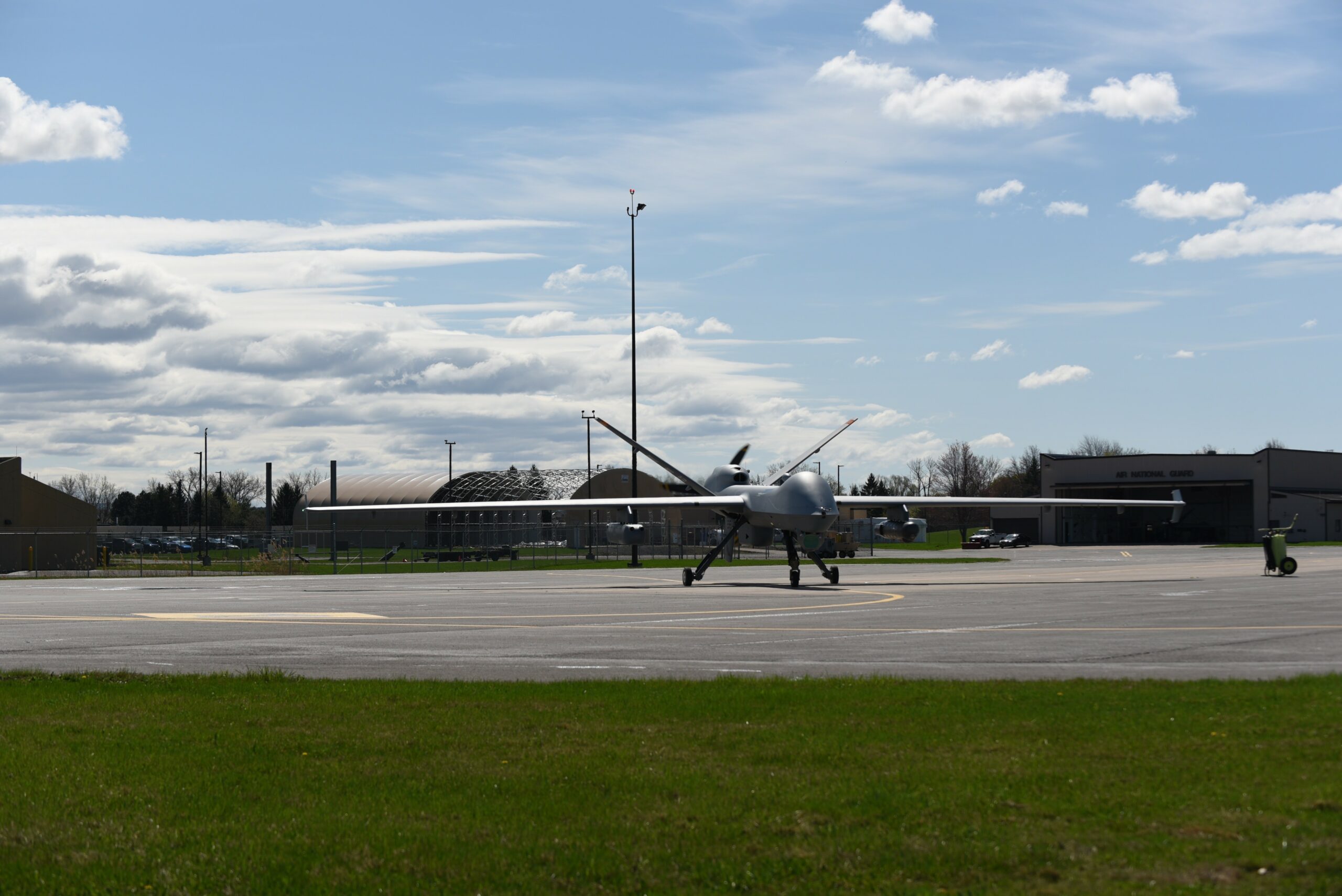 An MQ-9 Reaper with three Ghost Reaper pods attached awaits takeoff at Hancock Field Air National Guard Base, Syracuse, New York.