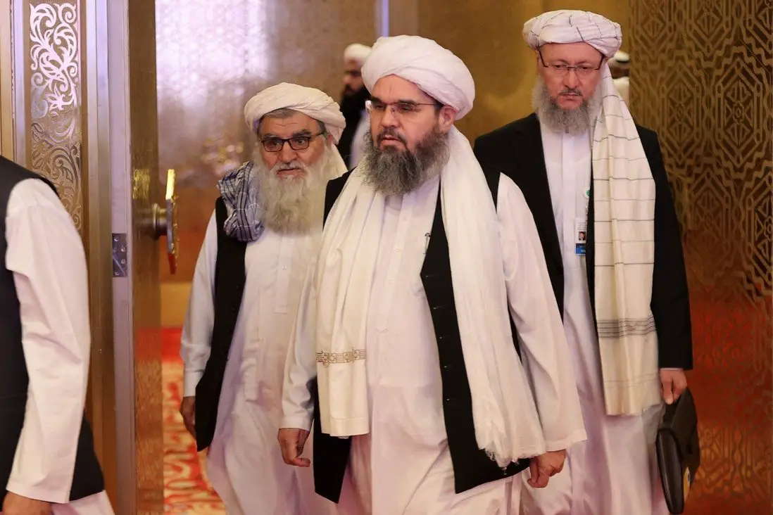 Members of the Taliban delegation arrive for peace talks between the Afghan government and the Taliban in Doha, Qatar on Sunday
