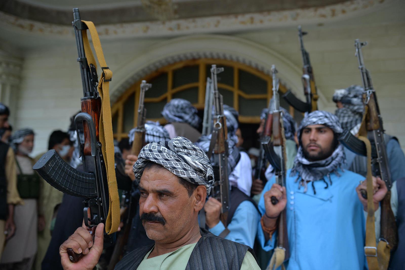 Afghan militia gather with their weapons to support Afghanistan security forces against the Taliban