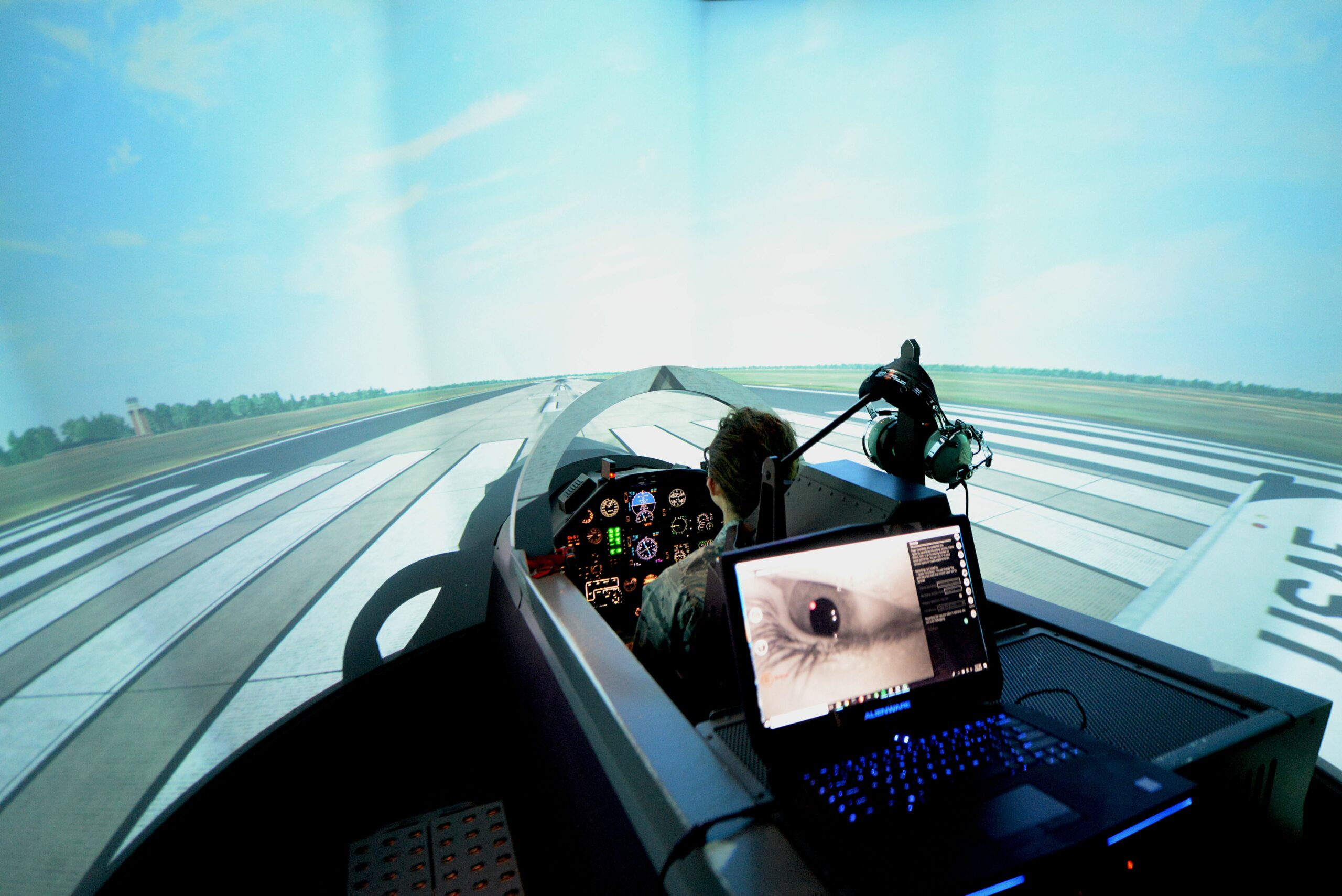 A student pilot prepares to take flight in the T-6 Texan II flight simulator.
