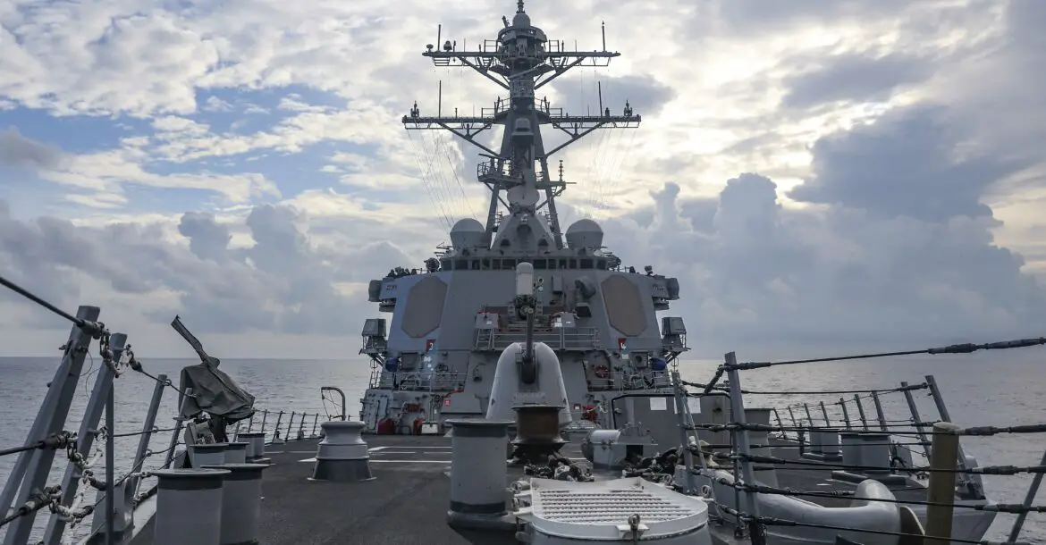The Arleigh Burke-class guided-missile destroyer USS Benfold (DDG 65) sails through the South China Sea while conducting routine underway operations