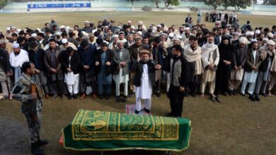 Afghan officials and mourners perform funeral prayers over the coffin of Angiza Shinwari, a provincial member, in Jalalabad