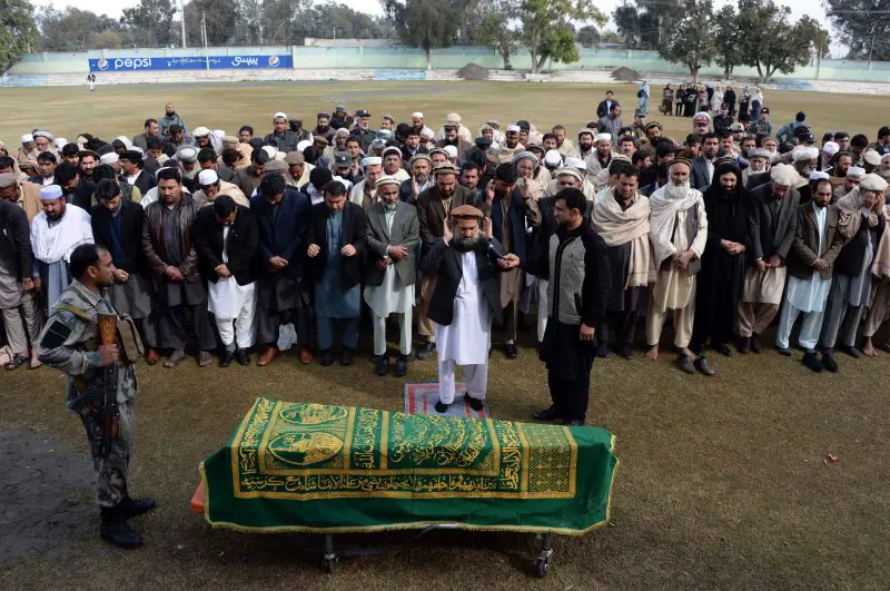Afghan officials and mourners perform funeral prayers over the coffin of Angiza Shinwari, a provincial member, in Jalalabad