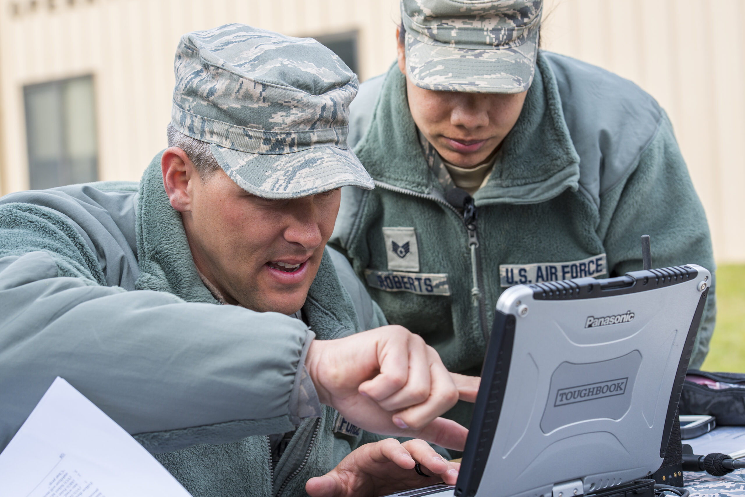 US Air Force Tech. Sgt. Cory Hebb, left, 820th Base Defense Group NCO in charge of Innovative Combat Equipment, and Staff Sgt. Rodshede Roberts, 820th Combat Operations Squadron technologies NCO, locate an RQ-11B Raven via GPS signal at Moody Air Force Base