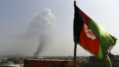 Smoke rises from the site of an attack after a massive explosion the night before near the Green Village in Kabul