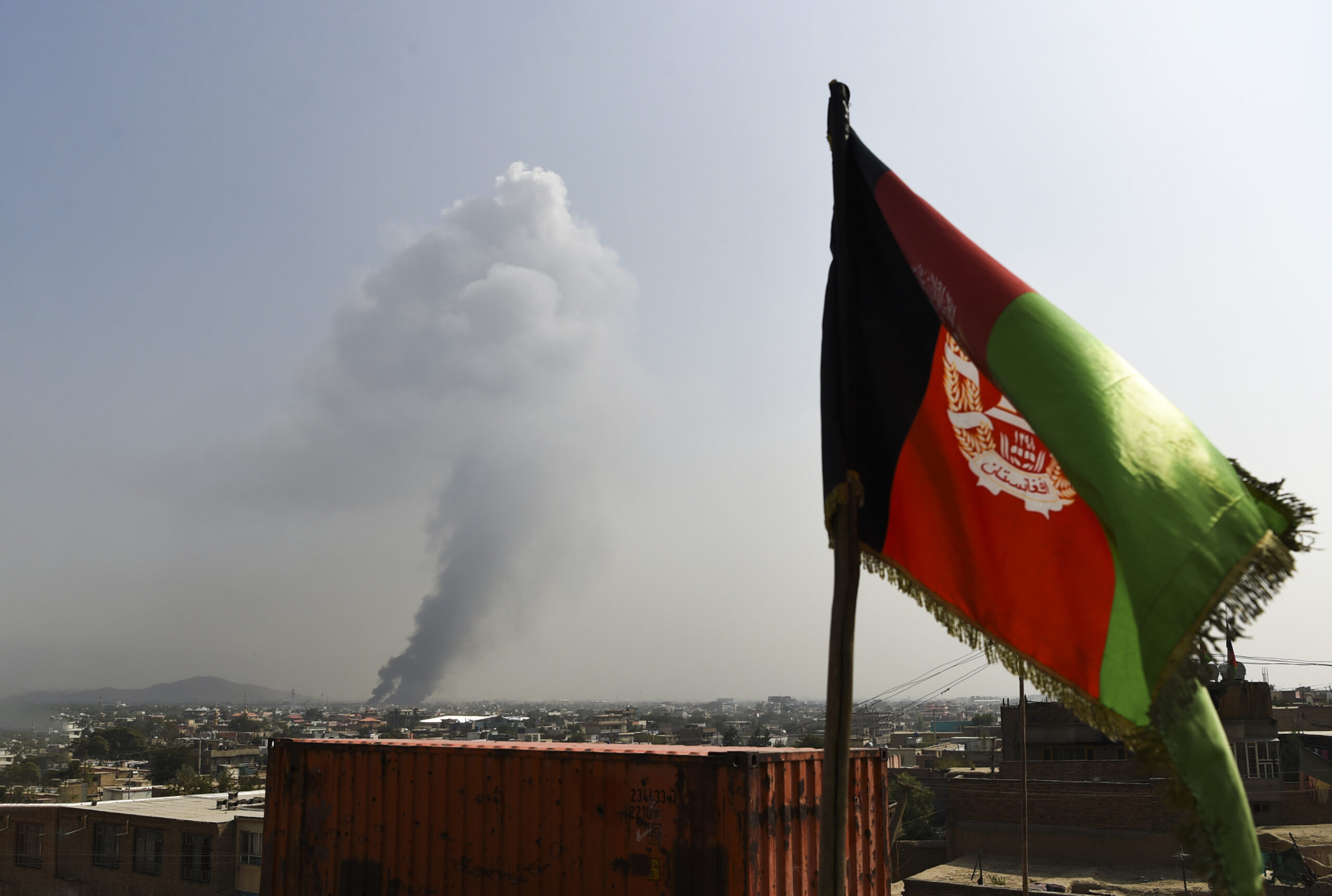 Smoke rises from the site of an attack after a massive explosion the night before near the Green Village in Kabul