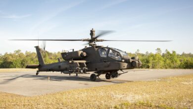 A Joint Air to Ground Missile (JAGM) is loaded onto an AH64E Apache Attack Helicopter