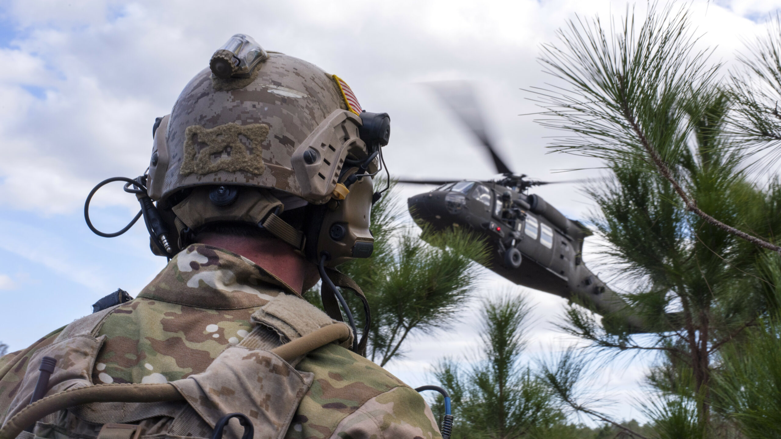 A US Navy SEAL team member awaits extraction from a UH-60 Black Hawk helicopter during an 2019 exercise