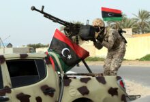 Libyan soldier standing on top of a car