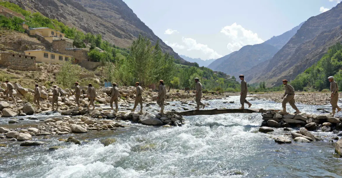 Anti-Taliban fighters crossing a river in the Panjshir valley