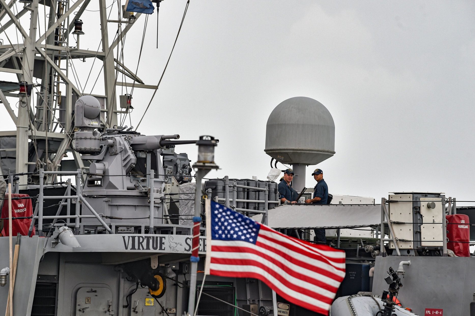 US Navy sailors stand guard aboard the USS Sirocco patrol ship