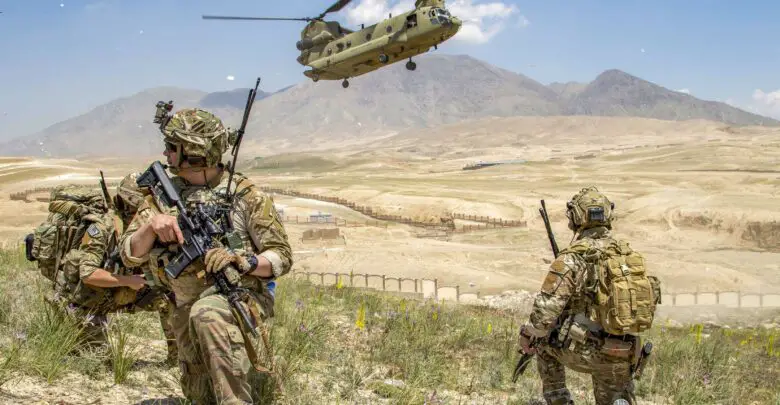 Soldiers from 1st Battalion, 121st Infantry Regiment of the 48th Infantry Brigade Combat Team provide security as a CH-47 Chinook helicopter lands after a key leader engagement in Southeastern Afghanistan
