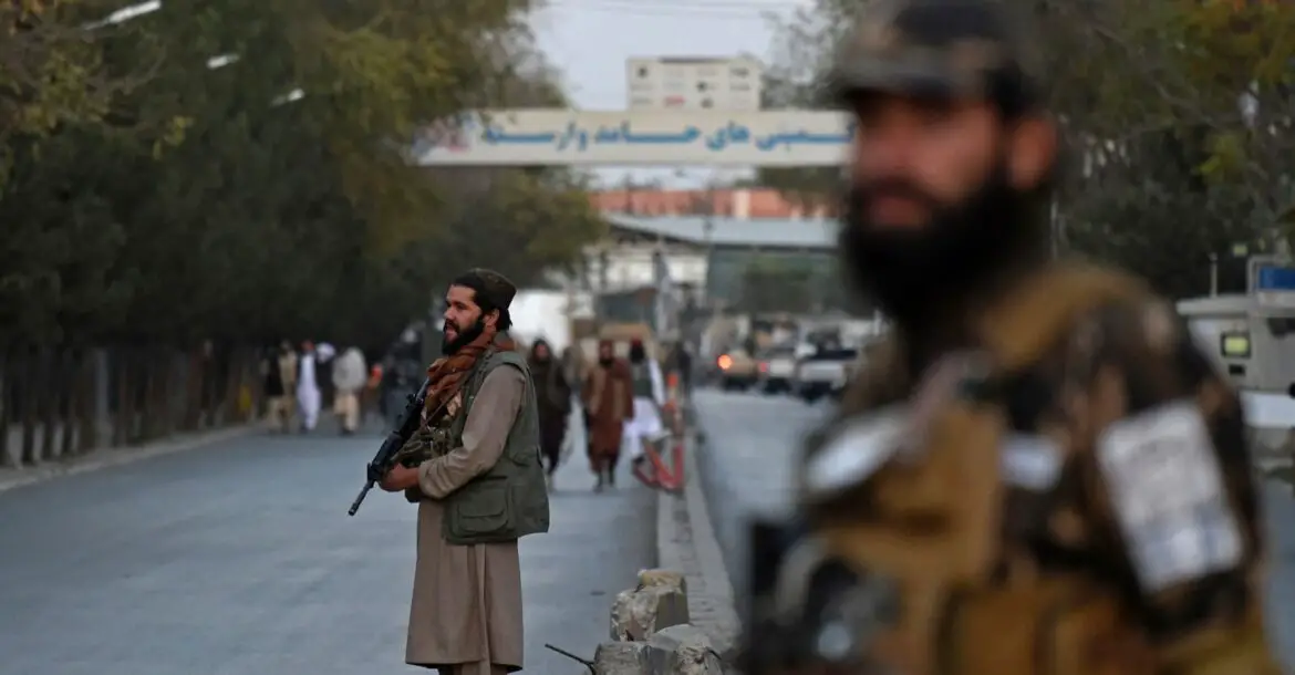 Taliban fighters stand guard near the Sardar Mohammad Dawood Khan military hospital in Kabul
