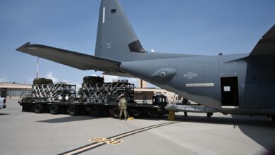 US Air Force personnel load a Rapid Dragon deployment system onto an MC-130J aircraft ahead of an airdrop