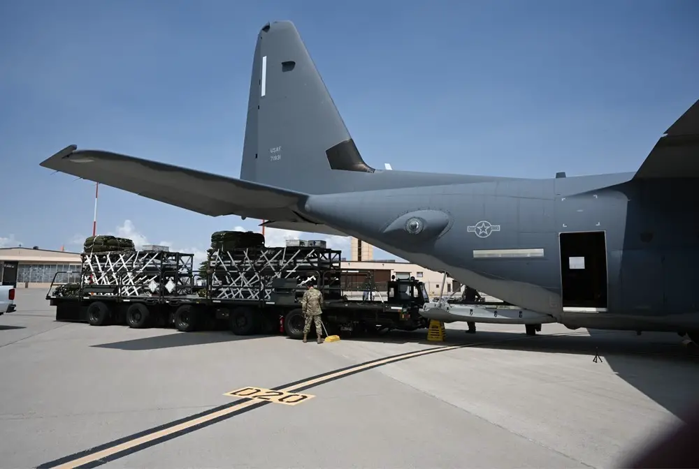 US Air Force personnel load a Rapid Dragon deployment system onto an MC-130J aircraft ahead of an airdrop