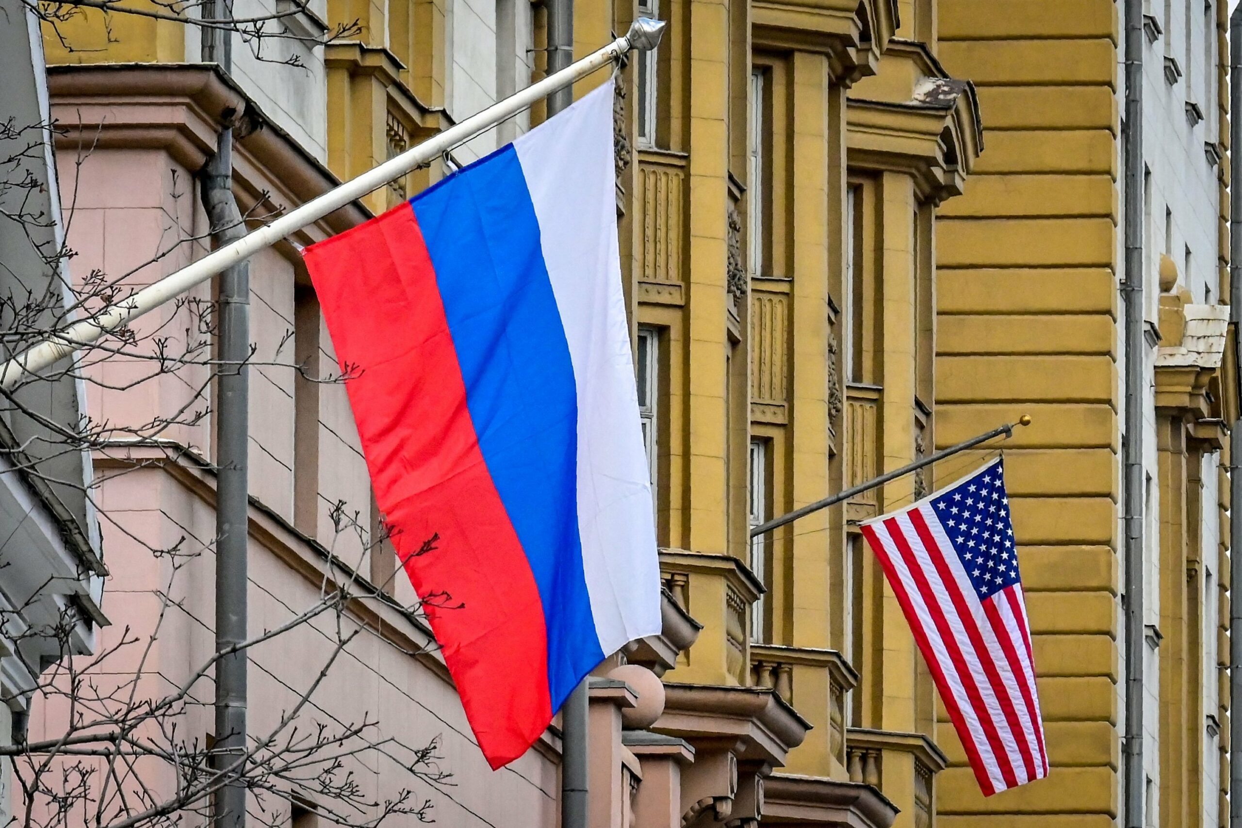 A Russian flag flies next to the US embassy building in Moscow