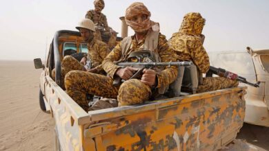 Fighters loyal to Yemen's Saudi-backed government hold a position against Houthi rebels