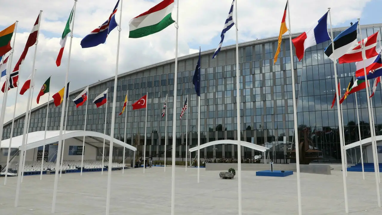 Flags of Alliance members flap in the wind outside NATO headquarters