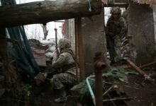 Ukrainian soldiers keep watch on the frontline with Russia-backed separatists