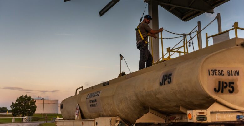 US army employee gauging fuel tanker