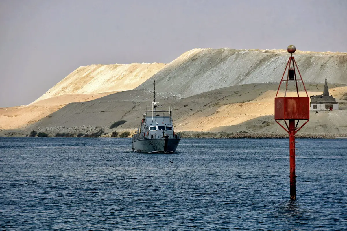 An Egyptian navy craft patrols as ships resume navigation in the Suez Canal