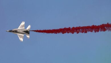 A Chinese Hongdu JL-10 (L-15) supersonic advanced jet trainer and light combat aircraft releases coloured smoke while performing aerial manoeuvres during the 2021 Dubai Airshow