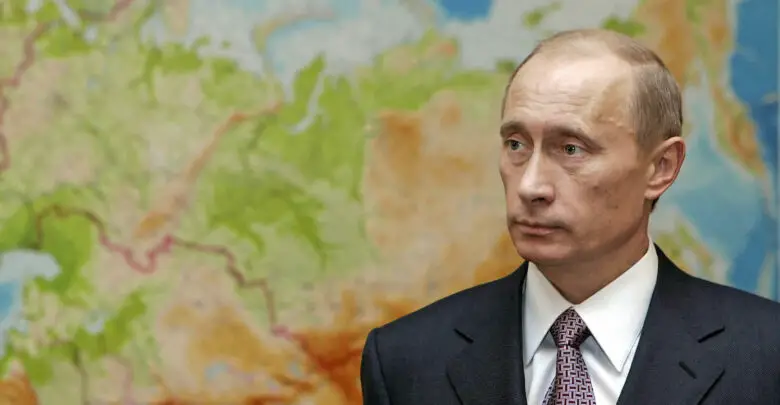 Russian President Vladimir Putin in front of a map in 2006