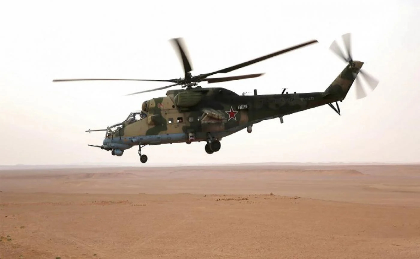 A Russian Mil Mi-24 "Hind" attack helicopter flying in the eastern Syrian region of Deir Ezzor