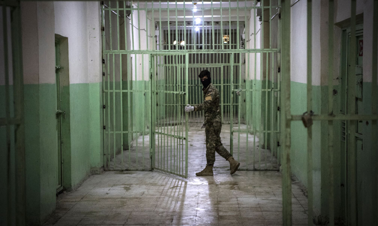 A member of the Syrian Democratic Forces serving guard in a prison in al-Hasakah province in northeastern Syria