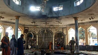 Taliban fighters investigate inside a Shiite mosque after a suicide bomb attack in Kunduz, Oct. 8, 2021