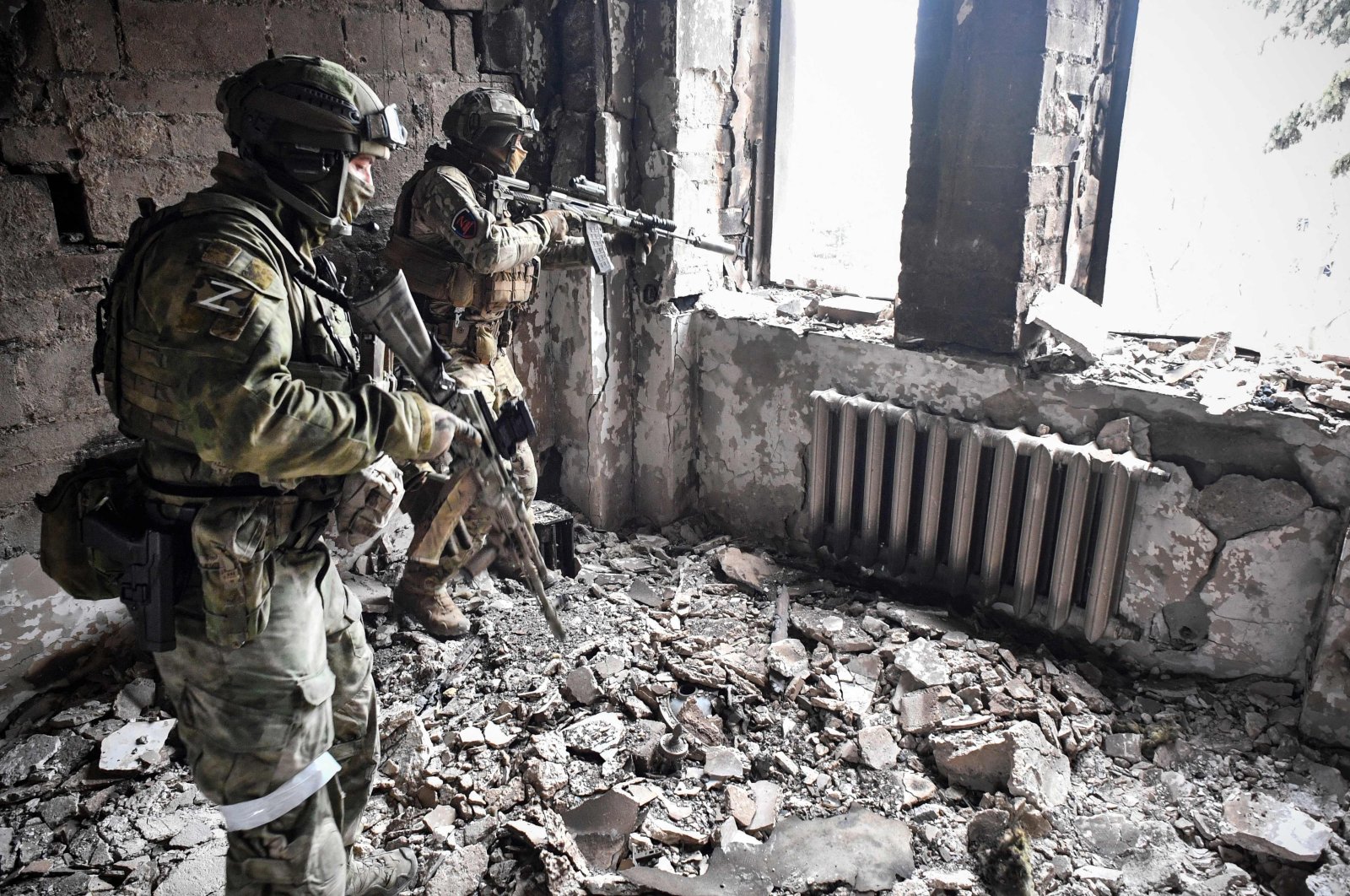 Two Russian soldiers patrol in the Mariupol drama theatre