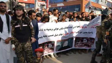 Demonstrators hold a banner during a protest against Pakistani airstrikes in Khost